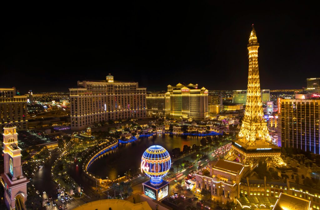 Aerial night view of Las Vegas Strip with iconic hotels Bellagio, Paris Las Vegas, Eiffel Tower replica